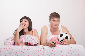 Image showing Husband watches football, frankly bored wife