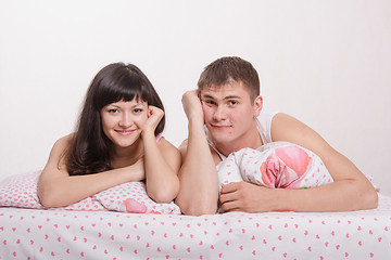 Image showing Happy young couple in bed smiling faces