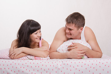 Image showing Man and woman smiling at each other in bed