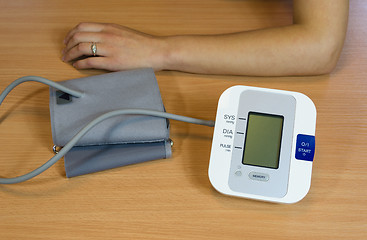 Image showing hands and digital blood pressure measurement  