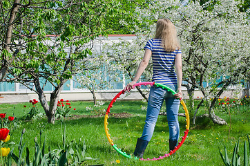 Image showing woman hold colorful hula hoop nature background  