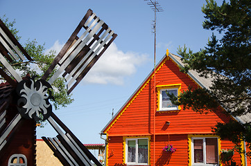 Image showing red wooden house and brown decorative mill wind  