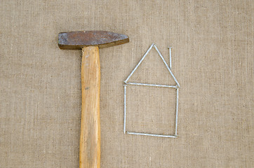 Image showing hammer and house made nail building home concept 