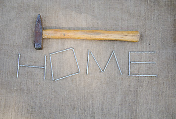 Image showing hammer and inscription of nails on linen texture   