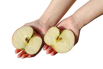 Image showing woman hold palms sawn apple sides with brown seeds 