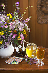 Image showing Still life from medicinal herbs, honey, herbal tea and medicines