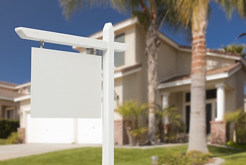 Image showing Blank Real Estate Sign in Front of New House 