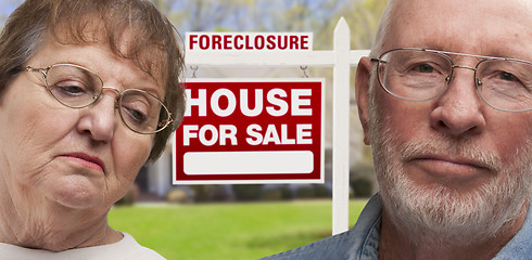 Image showing Depressed Senior Couple in Front of Foreclosure Sign and House