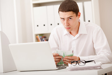 Image showing man with laptop and money