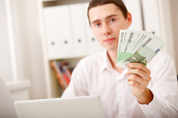 Image showing man with Euro in office