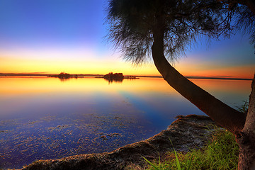 Image showing Sunbeams reflected in the water at sunset 