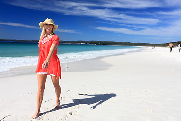 Image showing Happy woman walking along beautiful beach