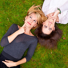 Image showing Two girls brainstorming in the meadow.