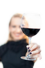 Image showing Toasting with a glass of red wine.