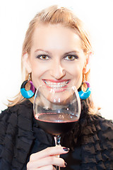 Image showing Toasting with a glass of red wine.