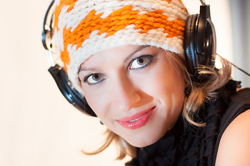 Image showing Blonde lady listening to the music.