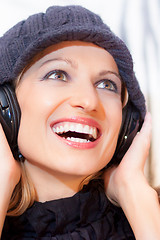 Image showing Blonde lady listening to the music.