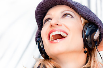 Image showing Blonde lady listening to the music.