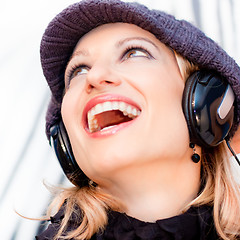 Image showing Blonde lady listening to the music.