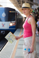 Image showing Young woman on platform of railway station.