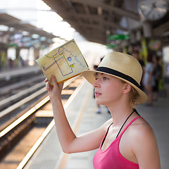 Image showing Young woman on platform of railway station.