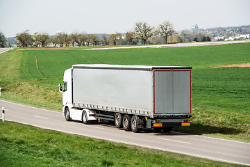 Image showing White truck moving on a main road