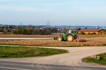 Image showing Tractor plowing a field