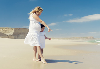 Image showing Pregnant woman and her daughter on the beach