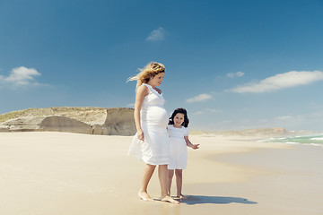 Image showing Pregnant woman and her daughter on the beach