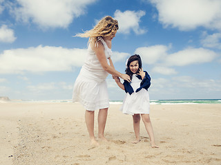 Image showing Woman and her daughter on the beach