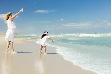 Image showing Modher and daughter throwing stones