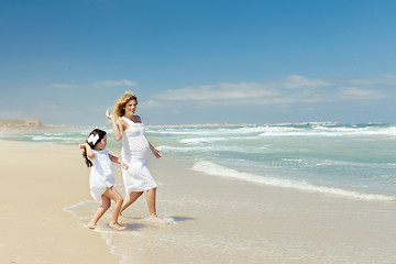 Image showing Modher and daughter throwing stones