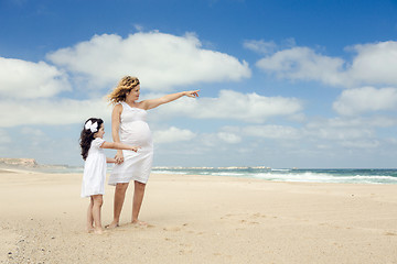 Image showing Pregnant woman and her daughter on the beach