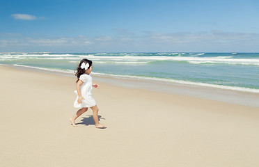 Image showing Girl walking on the beach