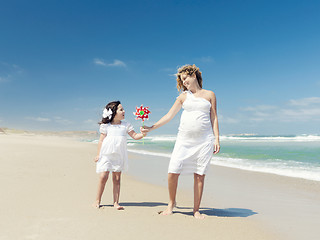 Image showing Mother and daughter holding a windmill