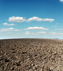 Image showing plowed field and cloudy sky