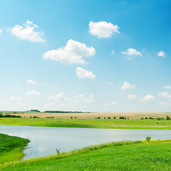 Image showing river in green grass under cloudy sky