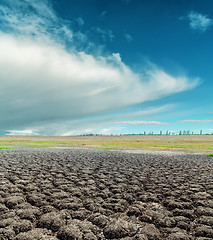 Image showing global warming. dramatic sky over cracked earth