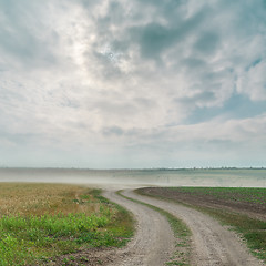 Image showing dirty road with dust and dramatic sky over it