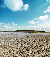 Image showing cracked desert and clouds in sky