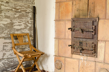 Image showing old rustic furnace doors and wooden rest chair 