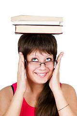 Image showing young beautiful girl in glasses with books on head. isolated on 