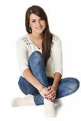 Image showing Smiling yong woman sitting on floor