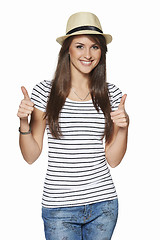 Image showing Happy excited young woman gesturing thumbs up