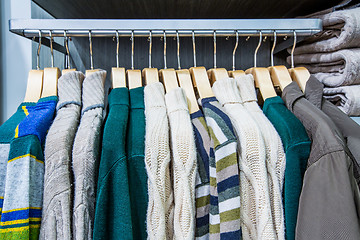 Image showing Clothing on hangers in shop