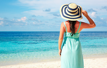 Image showing Girl walking along a tropical beach in the Maldives.