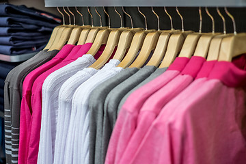 Image showing Clothing on hangers in shop