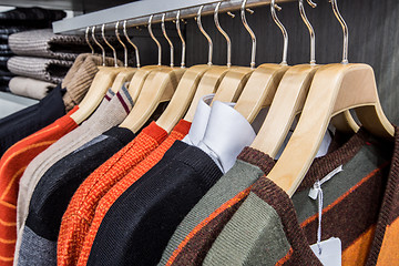 Image showing Clothing on hangers in shop