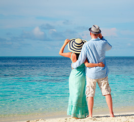 Image showing Vacation Couple walking on tropical beach Maldives.