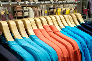 Image showing Clothing on hangers in shop